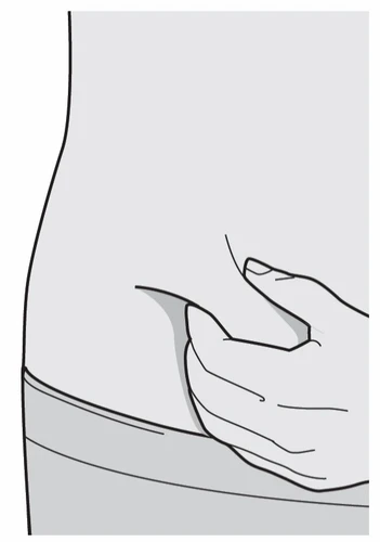 A hand pinches the skin of the