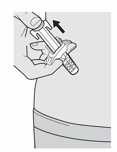 A hand holding a syringe-shaped medical device to apply it to the skin of the