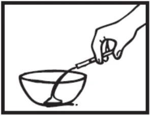 A hand holds a teaspoon and pours dark liquid into