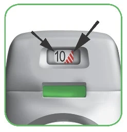 Close-up of a medical device with a display showing the number 10 next to a striped red section indicated by two black arrows