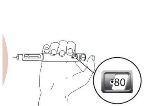Una mano sostiene un dispositivo médico horizontal con un aumento que muestra una pantalla digital con el número 80