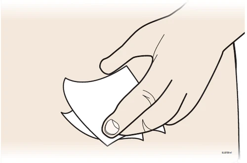 A hand gently lifting and holding a white sheet of paper with slightly curled corners against a light background