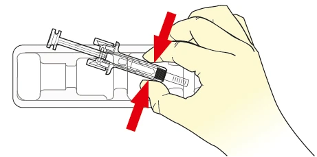 A hand pressing the plunger of a syringe downward