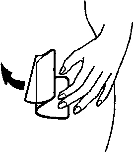 A hand lifting the lid of a container or medical device placed on a light-colored surface, with an arrow indicating the movement
