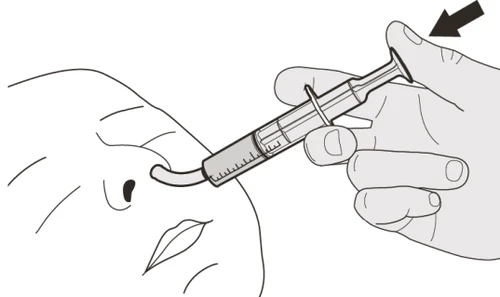 Technical drawing of a hand holding a syringe with a flexible tube inserted into a nostril of a human face in profile