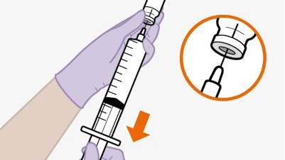 A gloved hand holding a syringe with needle inserted into a glass vial, with an inset magnification showing detail of the needle insertion