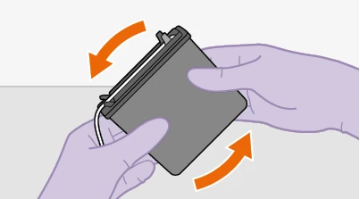 Two gloved hands holding a gray medical device, tilting it sideways in the direction indicated by two curved orange arrows