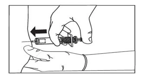 A hand holds a syringe horizontally while the
