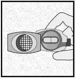 A hand holds a medical device composed of two gray parts, one with a circular grid and the