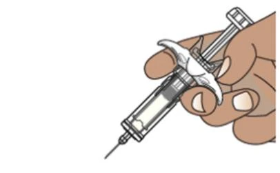A hand firmly holds a syringe with needle pointing downward to prepare the