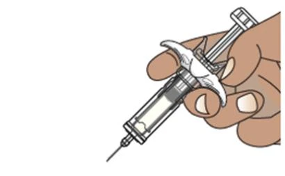 A hand firmly holds a syringe with needle pointing downward for preparation of a