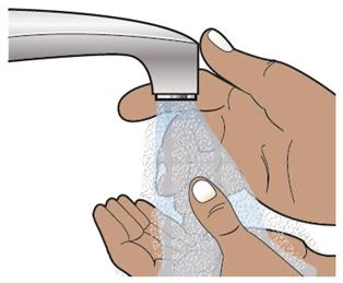 Two hands under an open faucet while the
