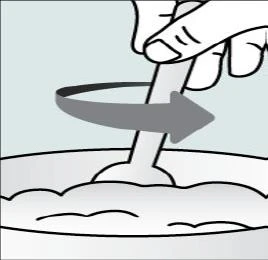 One hand holding a stick and rotating it in a circular motion