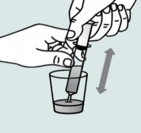 Two hands holding a syringe to immerse the tip