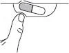 A finger presses the edge of a blister to extract a gray and white capsule enclosed in the cavity of the container