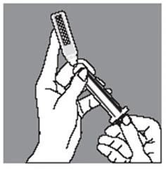 Two hands hold a syringe with the needle pointing toward the