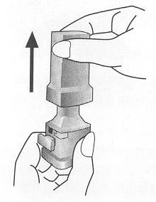 A hand holds the top part of a medical device while
