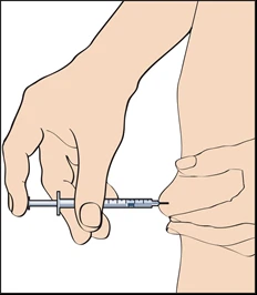 A hand holds a syringe horizontally while the