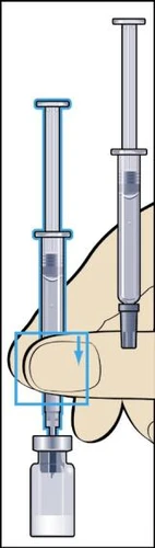 A hand holds a syringe vertically while the