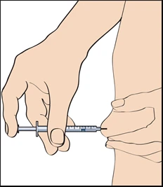 A hand holds a syringe horizontally while the