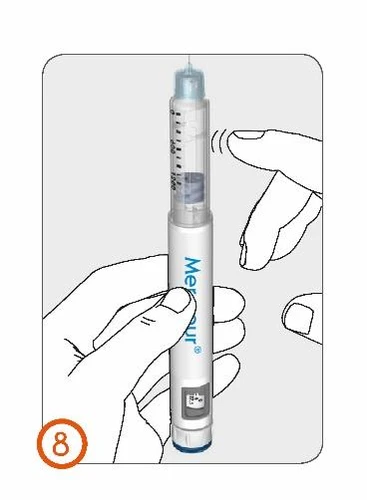 A hand grips a vertical injection pen while the thumb of the
