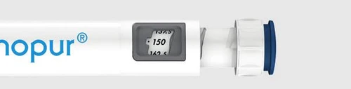 Detail of a white medical device with blue text 'nopur' and a small digital display showing the number 150 between 137.5 and 162.5