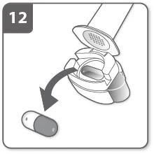 Dibujo técnico que muestra un dispositivo médico con la tapa abierta y una flecha que indica la liberación de una cápsula hacia abajo