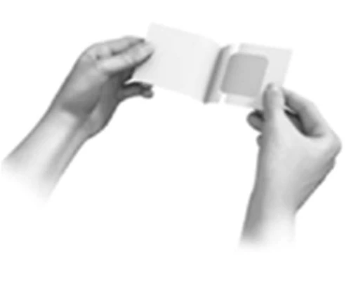 Two hands hold open a small white rectangular pouch to extract an internal patch or medical device