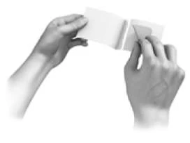 Two hands hold and unfold a folded leaflet with a motion outward