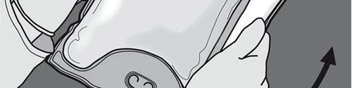 Hands holding and lifting a flat medical device with a small oval element in the center on a light gray background