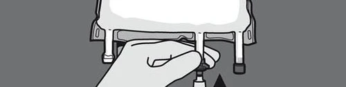 A hand pressing a button located on a white medical device with two vertical supports on a gray background