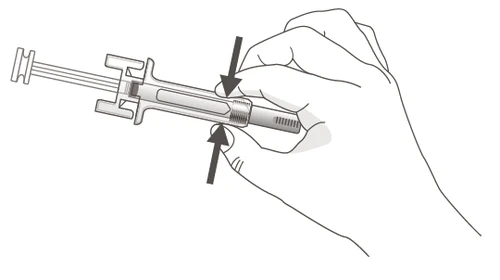 A hand gripping a pre-filled syringe with fingers, indicated by two black arrows pointing toward the center of the device for pressing