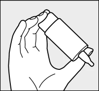 Una mano tiene un frasco de medicamento inclinado para verter su contenido a través de un cuentagotas integrado en la tapa