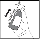 A hand holds a dark vial with a