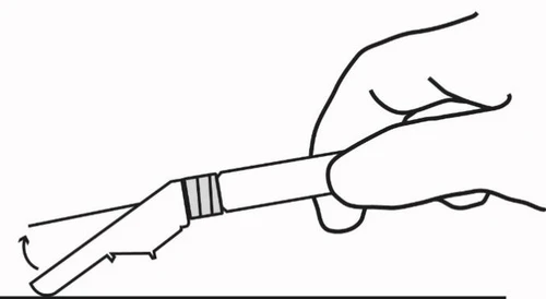 One hand holding a cylindrical medical device and tilting it downward following the direction indicated by a curved arrow