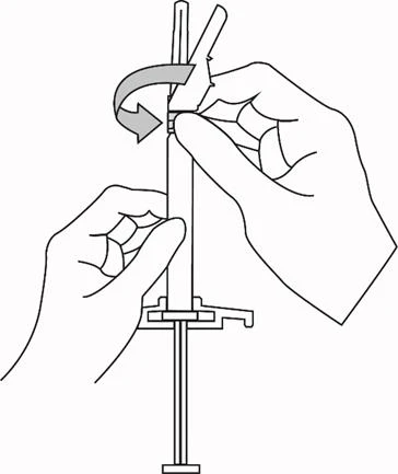 Two hands rotating the top part of a syringe to the left, following the direction of a curved arrow to prepare the device