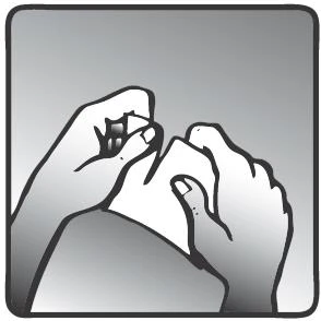 Two hands holding and manipulating a small container or paper wrapper against a softly shaded gray background