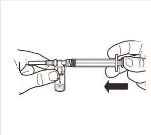 Two hands preparing medication by drawing liquid from a small vial into a syringe to the left, indicated by a black arrow