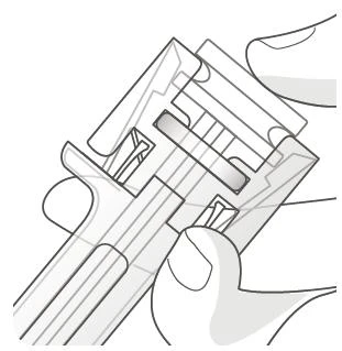 Two hands holding and manipulating a transparent medical device with internal components and a grooved structure for the