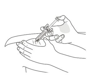 A hand holds a syringe at an angle while the