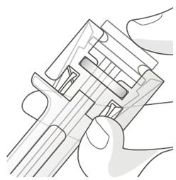 Two hands holding and maneuvering a transparent medical device with internal components and a grooved structure for the