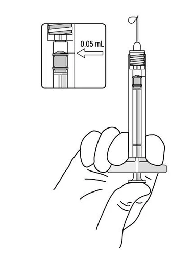 A hand holding a syringe with needle pointing upward