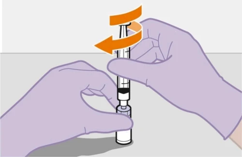 Two gloved hands holding a syringe with dark liquid while an orange arrow indicates rotational movement to unscrew the device
