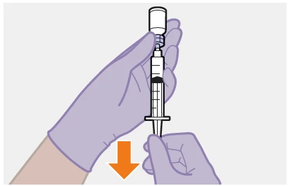 Gloved hands holding a syringe with dark liquid beneath a white vial with an orange downward-pointing arrow