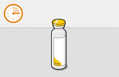 Glass vial with yellow cap and white label marked '3 mL' next to a