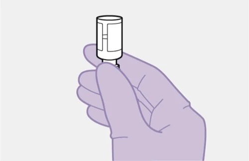 A lilac-colored gloved hand holding vertically a white vial with label and cap on a light gray background