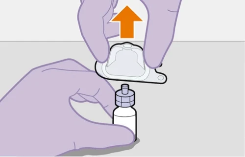 Purple-gloved hands lifting a transparent protective cap from a white vial with a blue cap, indicated by an orange upward arrow