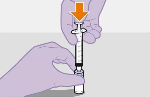 Two hands holding a syringe with a plunger being pressed downward, indicated by an orange arrow on a light gray background