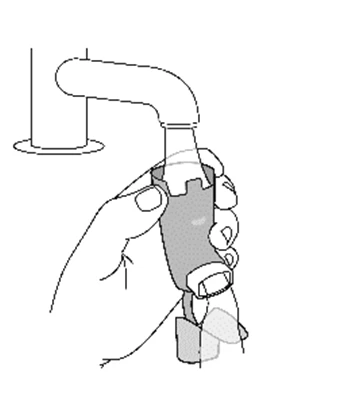 Una mano sostiene y gira un dispositivo médico cilíndrico con una parte superior curva y una base moldeada para la