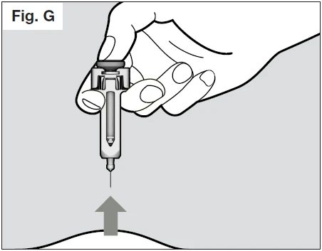 A hand holding a syringe ready for